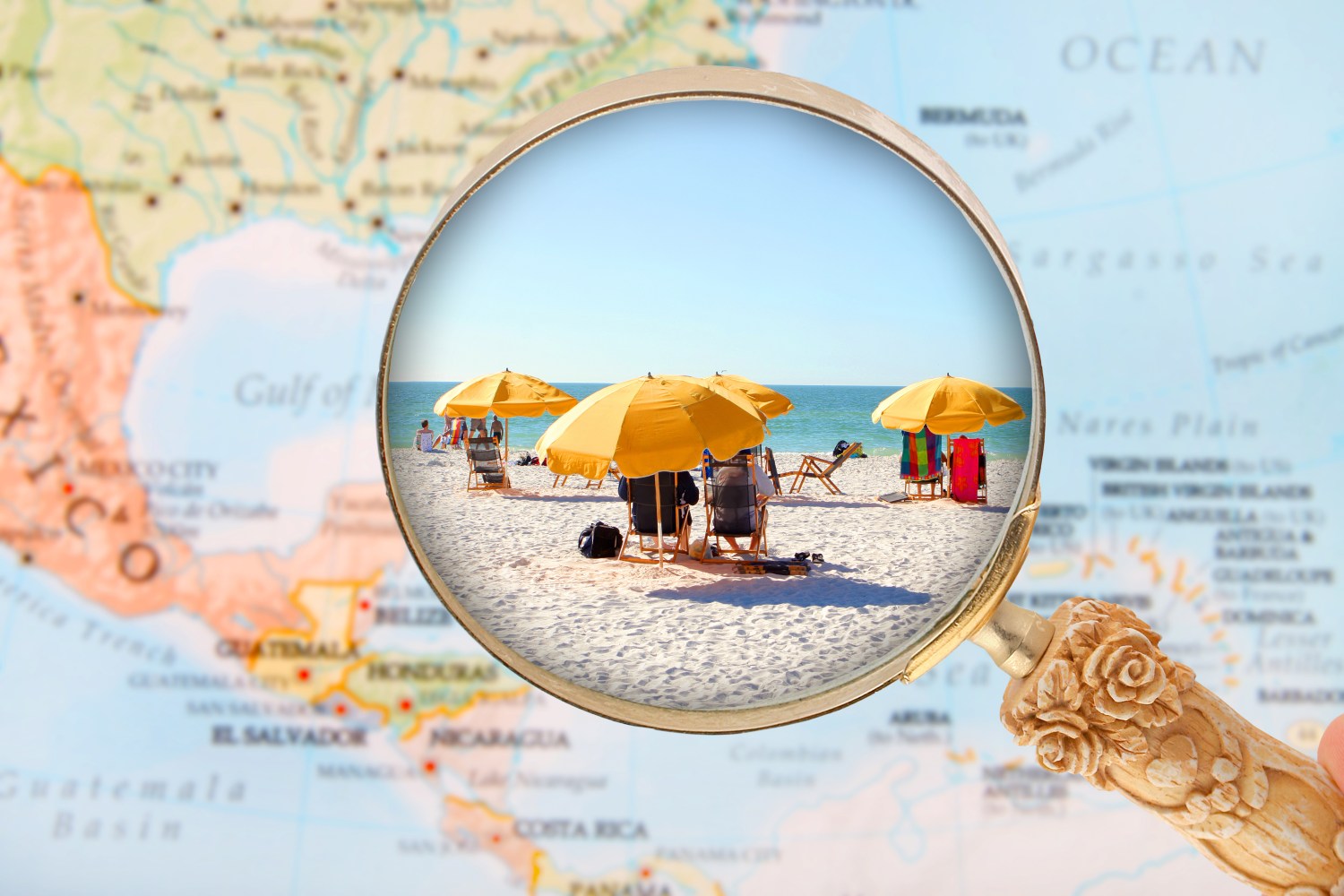 Magnifying glass showing a beach scene with yellow umbrellas on a map background.