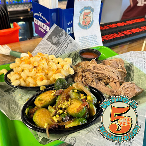 Plate with macaroni, sprouts, and shredded meat on a green tray with logo.