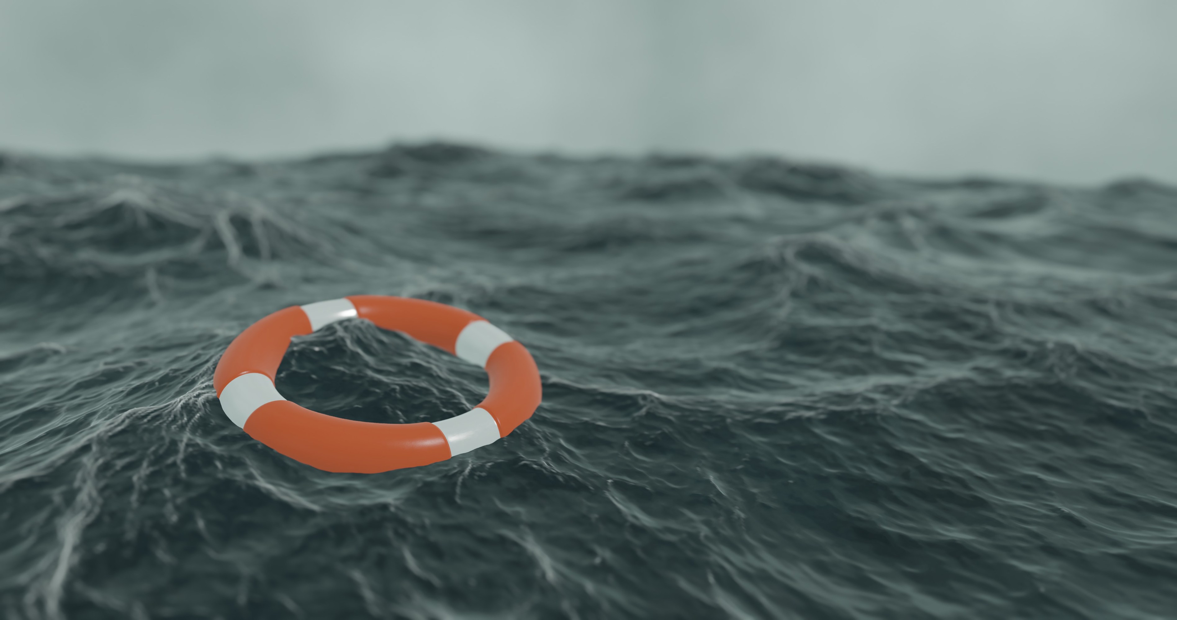 Orange lifebuoy floating on a choppy sea.
