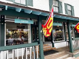 Exterior of a vintage building with 'Old Florida' sign and red flags on porch.