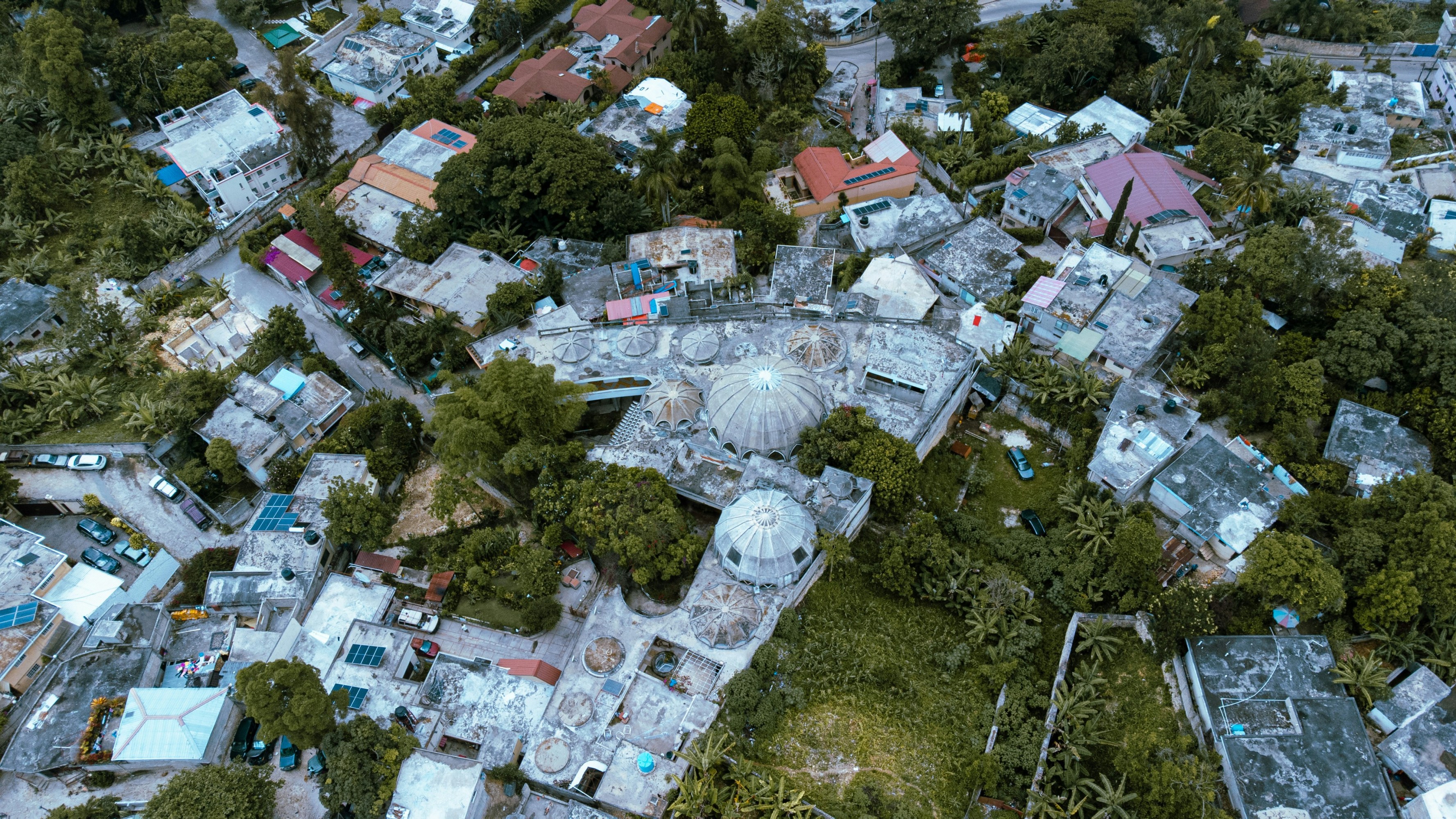 Aerial view of a residential area with a mix of houses and greenery.